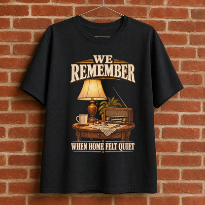 Black vintage t-shirt hanging with printed “We Remember When Home Felt Quiet” design