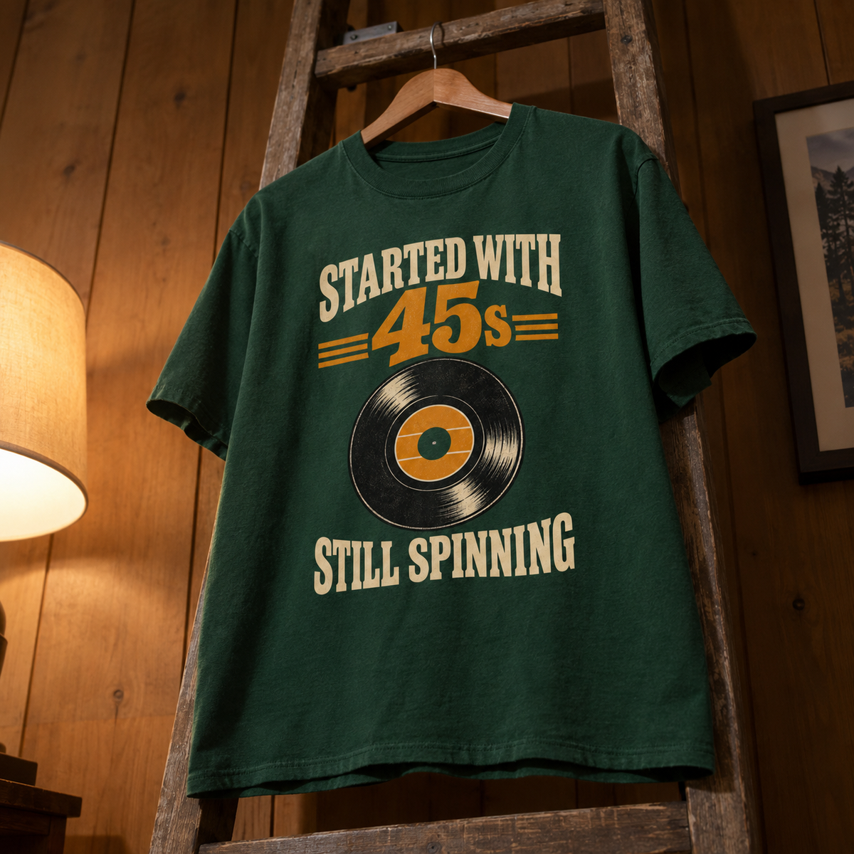 Green vintage t-shirt hanging with printed Started With =45s= Still Spinning record design