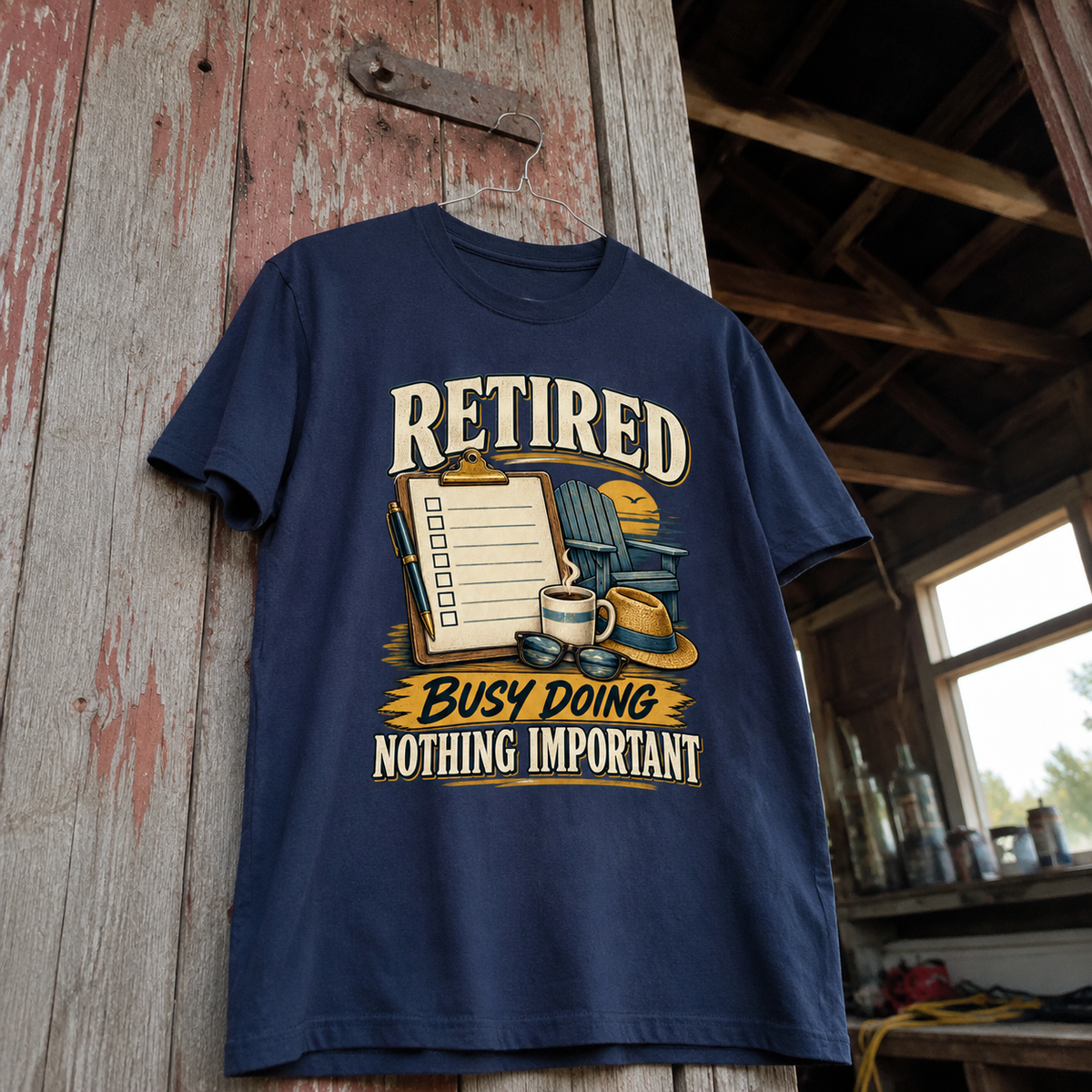 Navy vintage t-shirt hanging with printed “Retired. Busy Doing Nothing Important” design in rustic setting