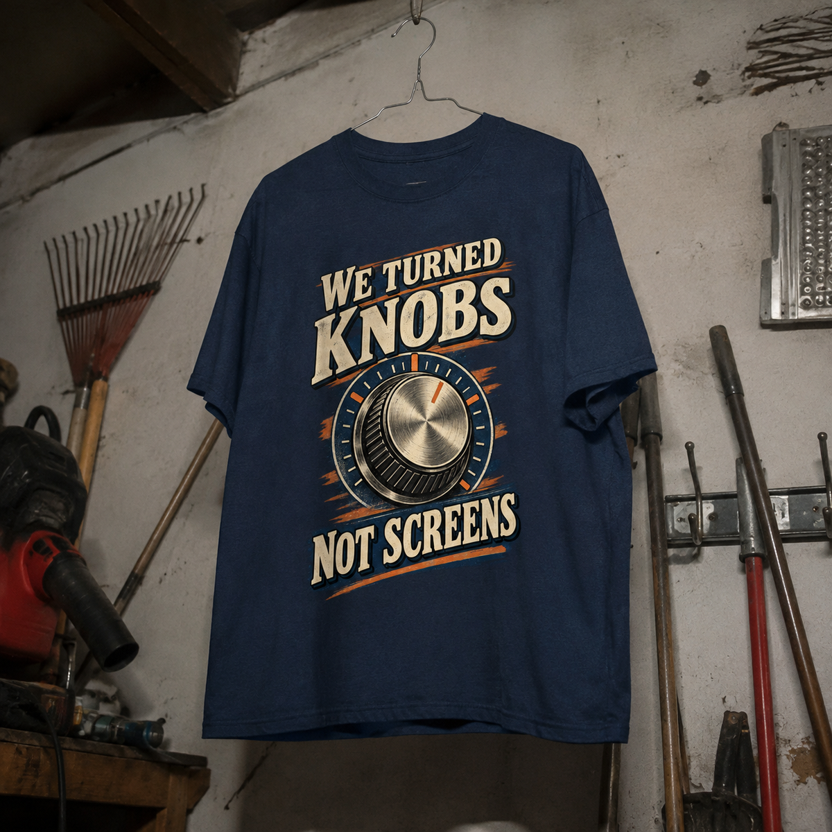 Navy vintage t-shirt hanging with printed We Turned Knobs Not Screens design