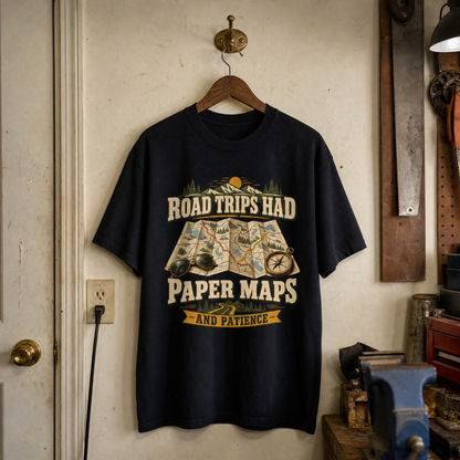 Black vintage t-shirt hanging with printed “Road Trips Had Paper Maps And Patience” design