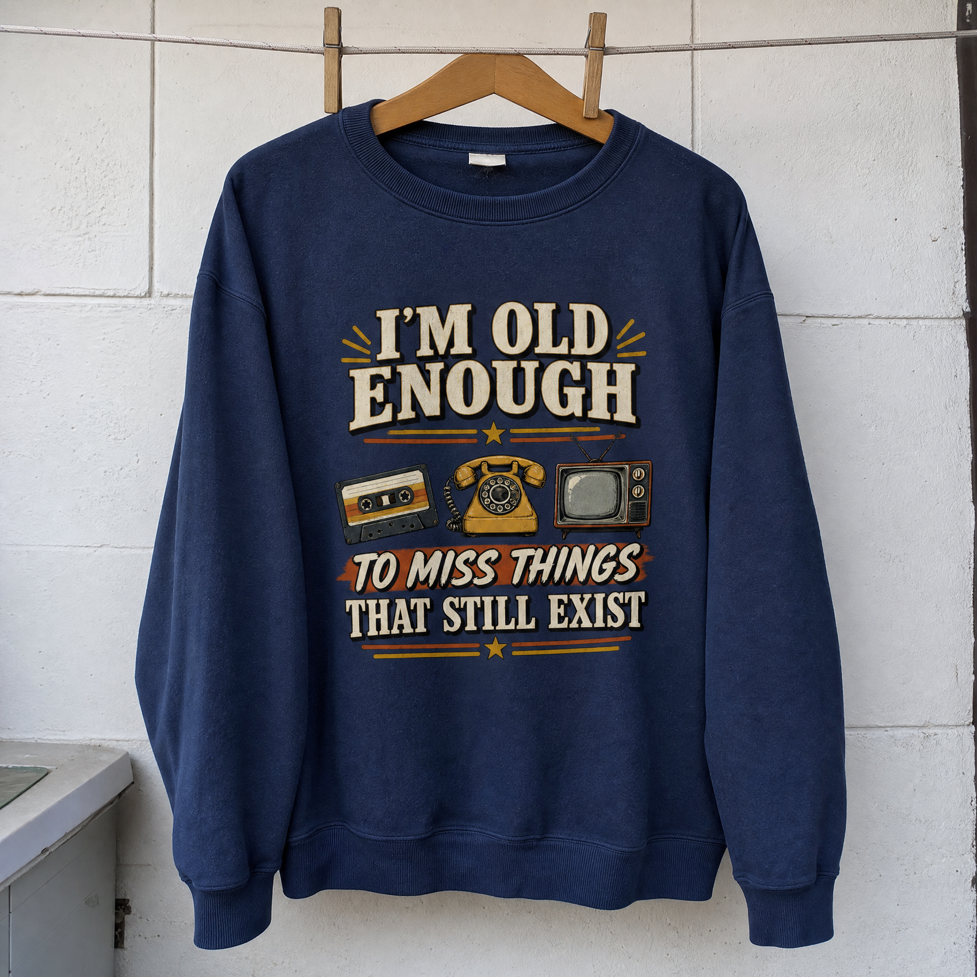 Vintage sweatshirt hanging with printed “42 miss things that still exist” slogan on front