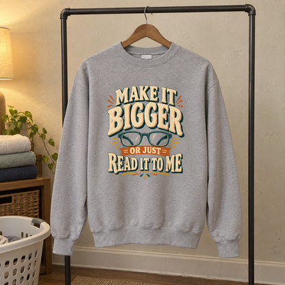 Gray vintage sweatshirt hanging, printed glasses and “Make It Bigger Or Just Read It To Me”