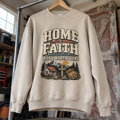 Cream vintage sweatshirt hanging in workshop with printed Home Faith Work Worth Doing design