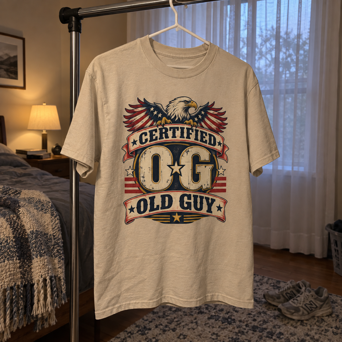 Cream vintage t-shirt hanging front-facing with printed eagle and Certified OG Old Guy design.