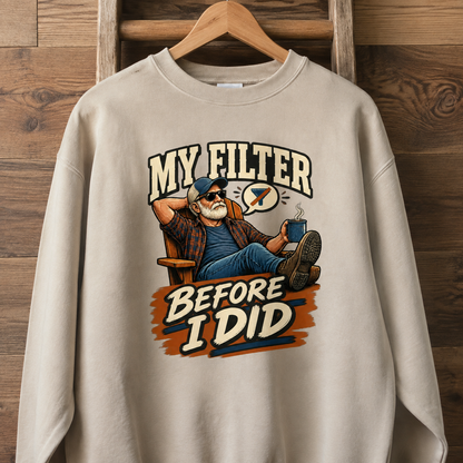 Beige vintage sweatshirt with printed “My Filter Before I Did” design hanging on wooden wall