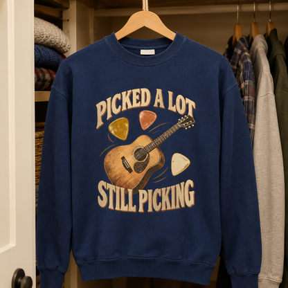 Navy vintage sweatshirt hanging with printed Picked A Lot Still Picking guitar design