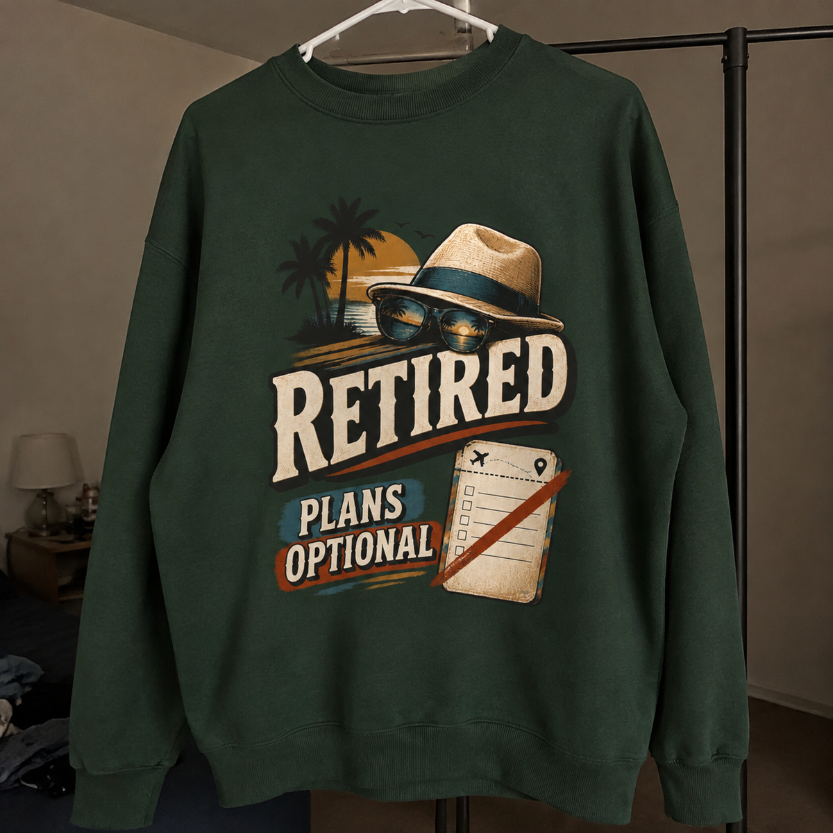 Green vintage sweatshirt hanging with printed Retired Plans Optional design front view