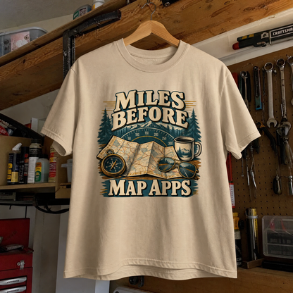 Cream vintage t-shirt hanging with printed Miles Before Map Apps slogan and map design