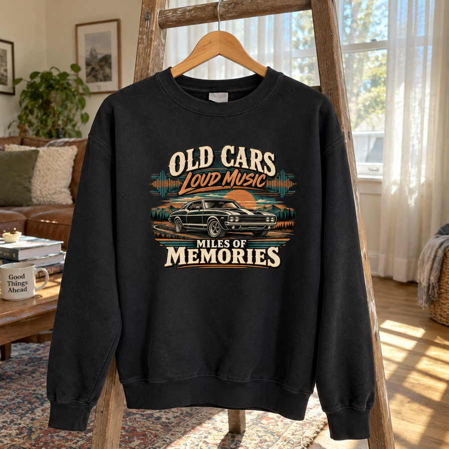 Black vintage sweatshirt hanging on wooden hanger with printed car and memories slogan