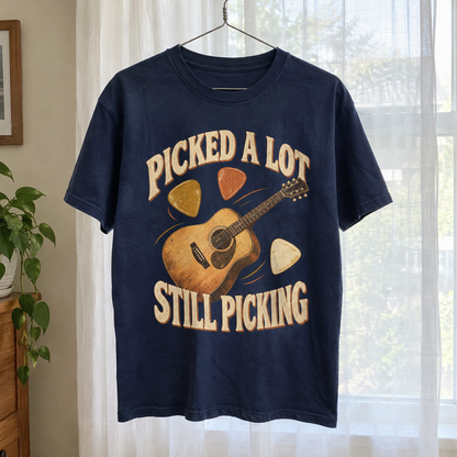 navy vintage t-shirt hanging on hanger with printed Picked A Lot Still Picking guitar design