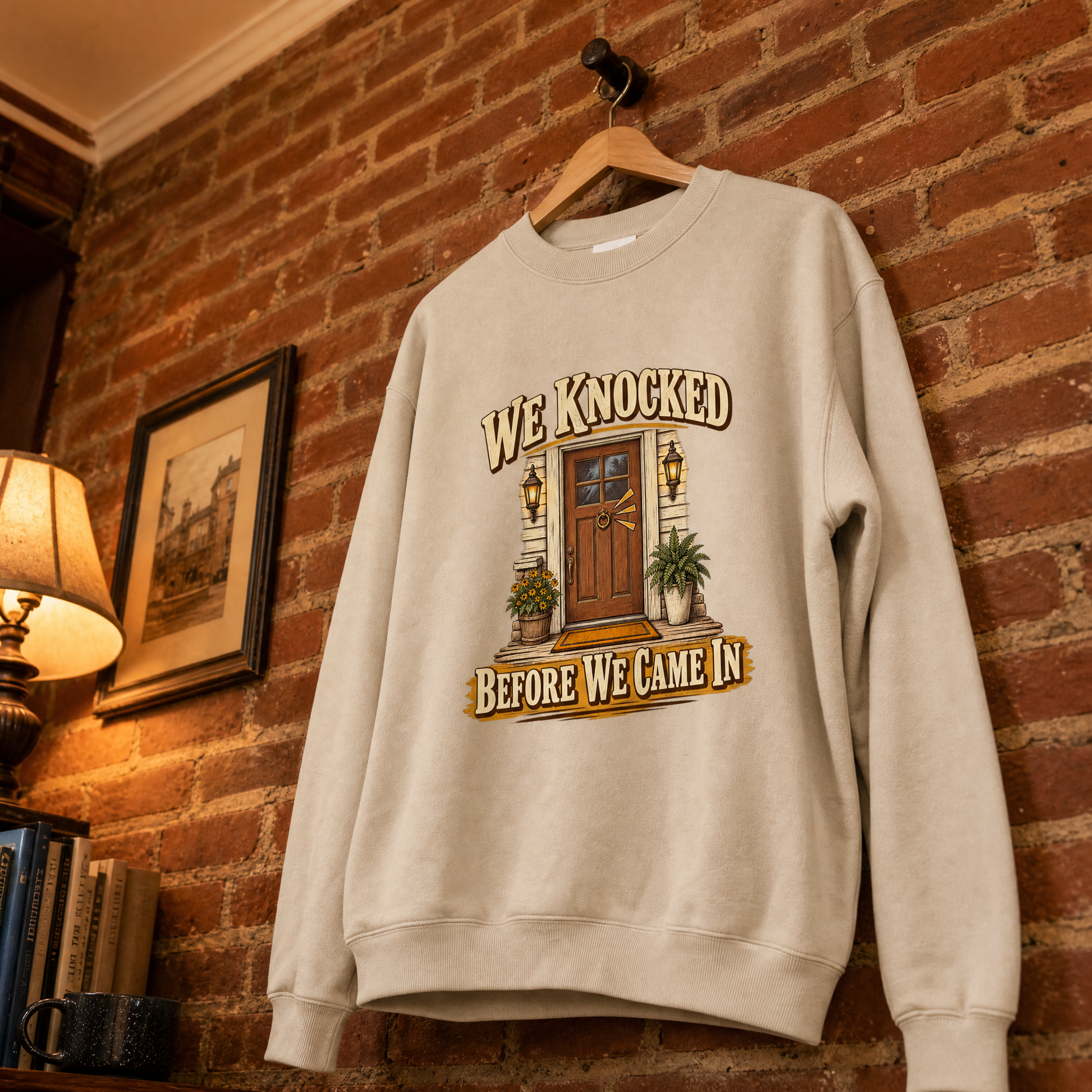 Cream vintage sweatshirt hanging with printed We Knocked Before We Came In design