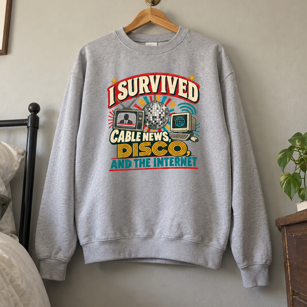 Gray vintage sweatshirt hanging with printed I Survived Cable News, Disco, and the Internet