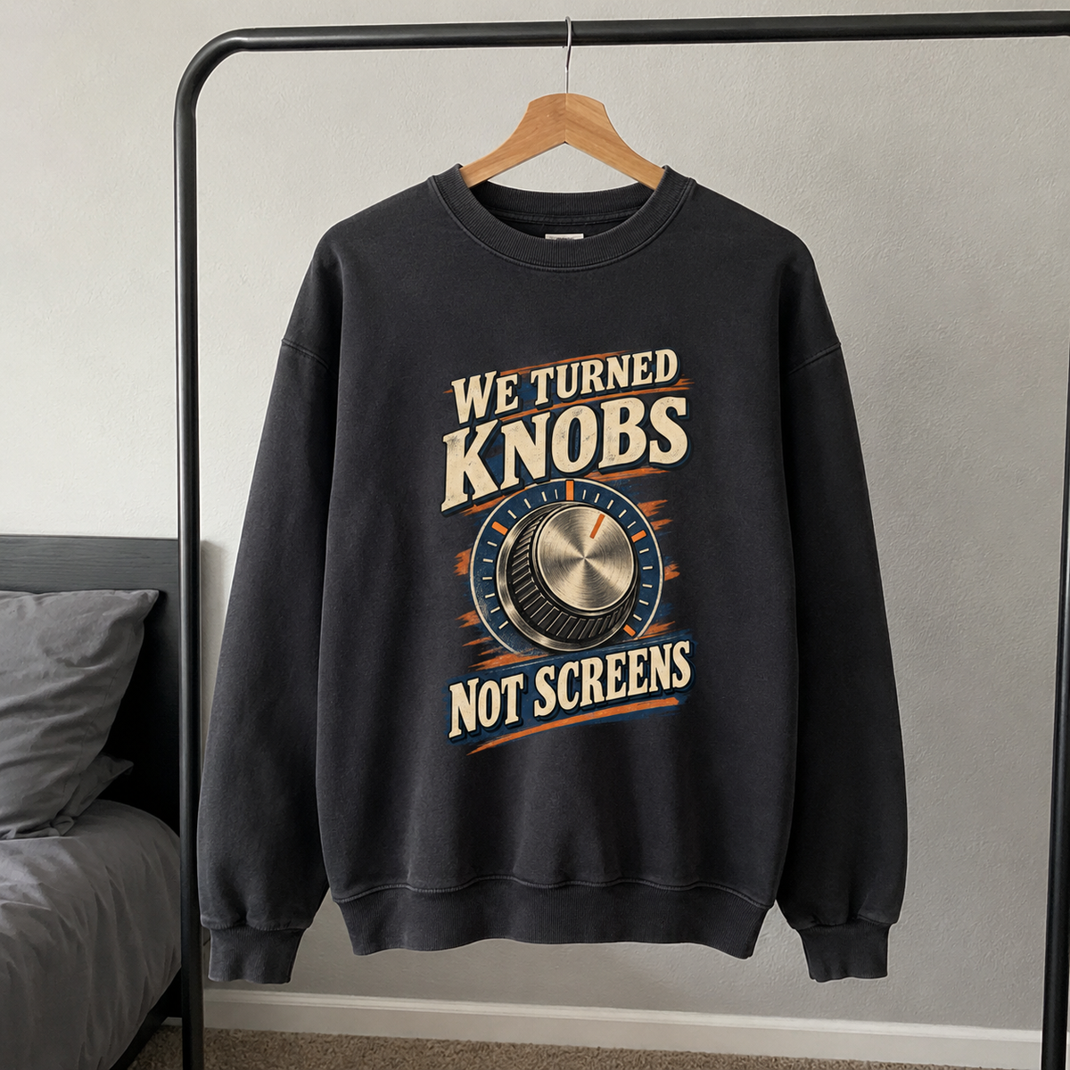 Black vintage sweatshirt hanging with printed We Turned Knobs Not Screens design