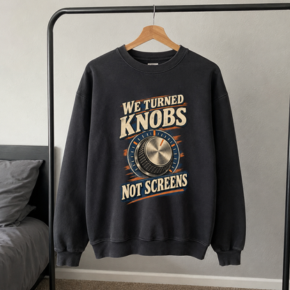 Black vintage sweatshirt hanging with printed We Turned Knobs Not Screens design