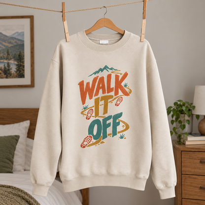 Cream vintage sweatshirt hanging with printed Walk It Off mountain trail design