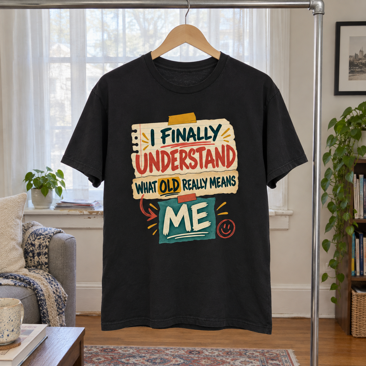 Black vintage t-shirt hanging on wooden hanger with colorful printed aging slogan.