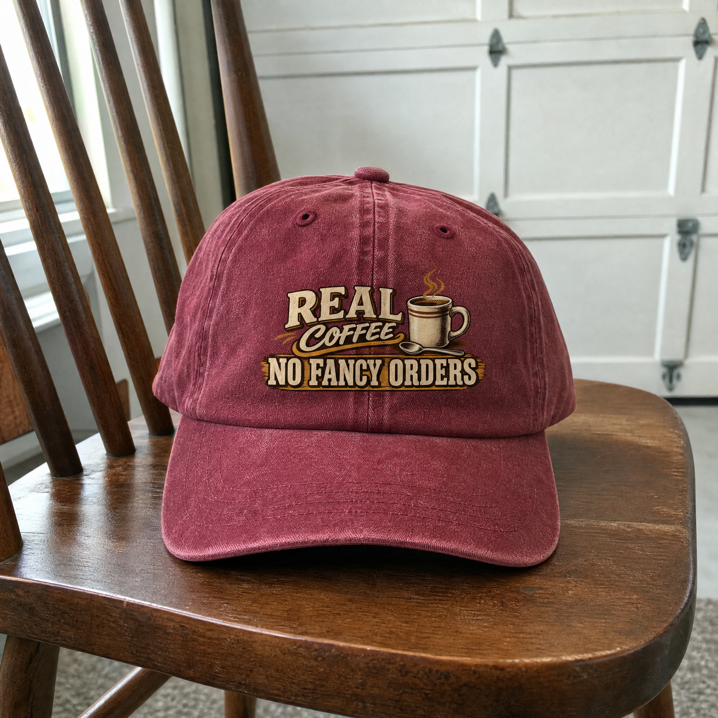 Burgundy vintage washed cap featuring printed “Real Coffee. No Fancy Orders” slogan.
