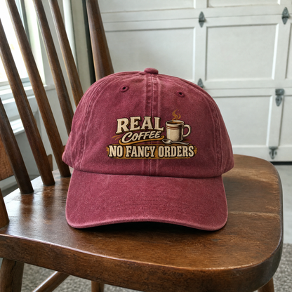 Burgundy vintage washed cap featuring printed “Real Coffee. No Fancy Orders” slogan.