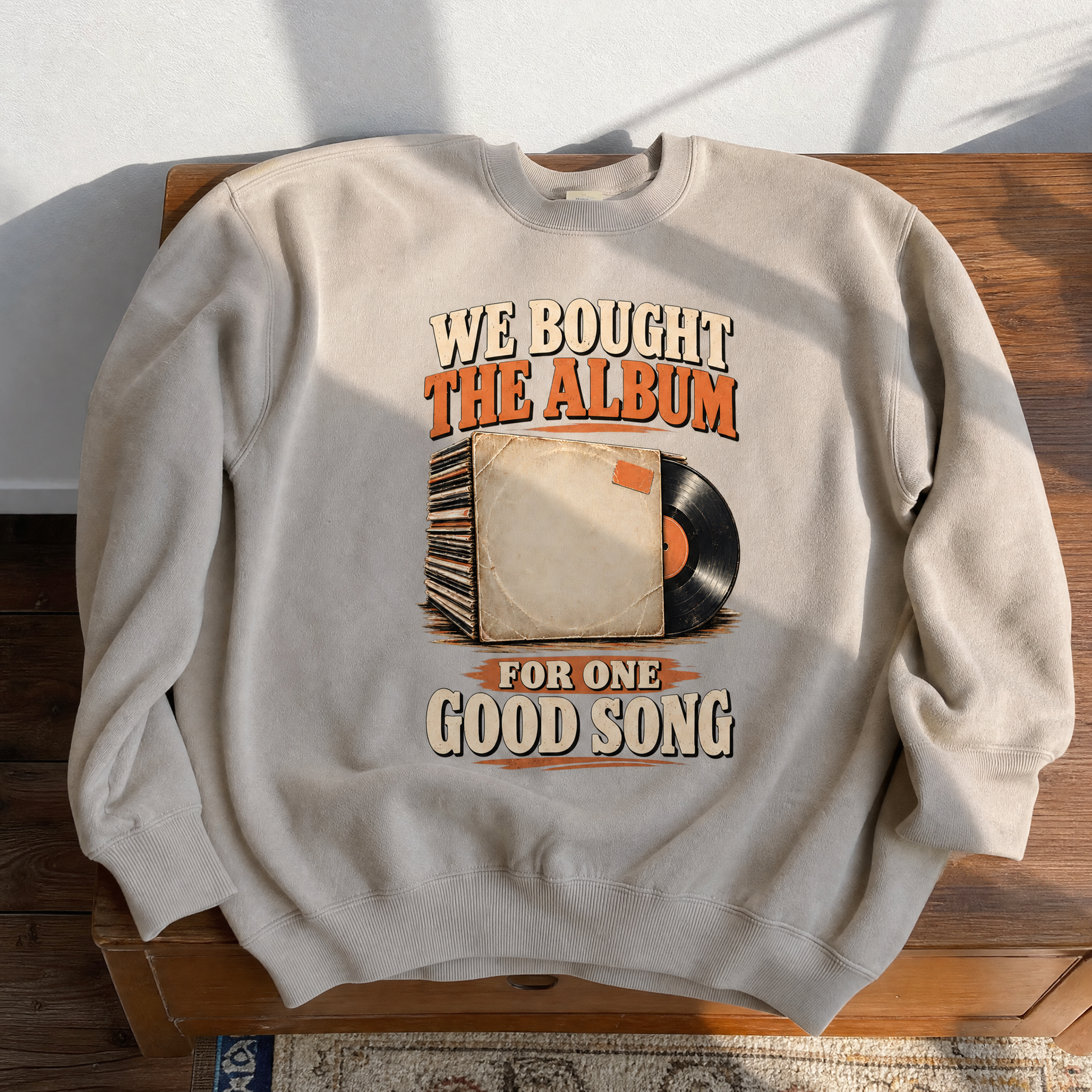 Vintage sweatshirt printed with “We Bought The Album For One Good Song” and record design.