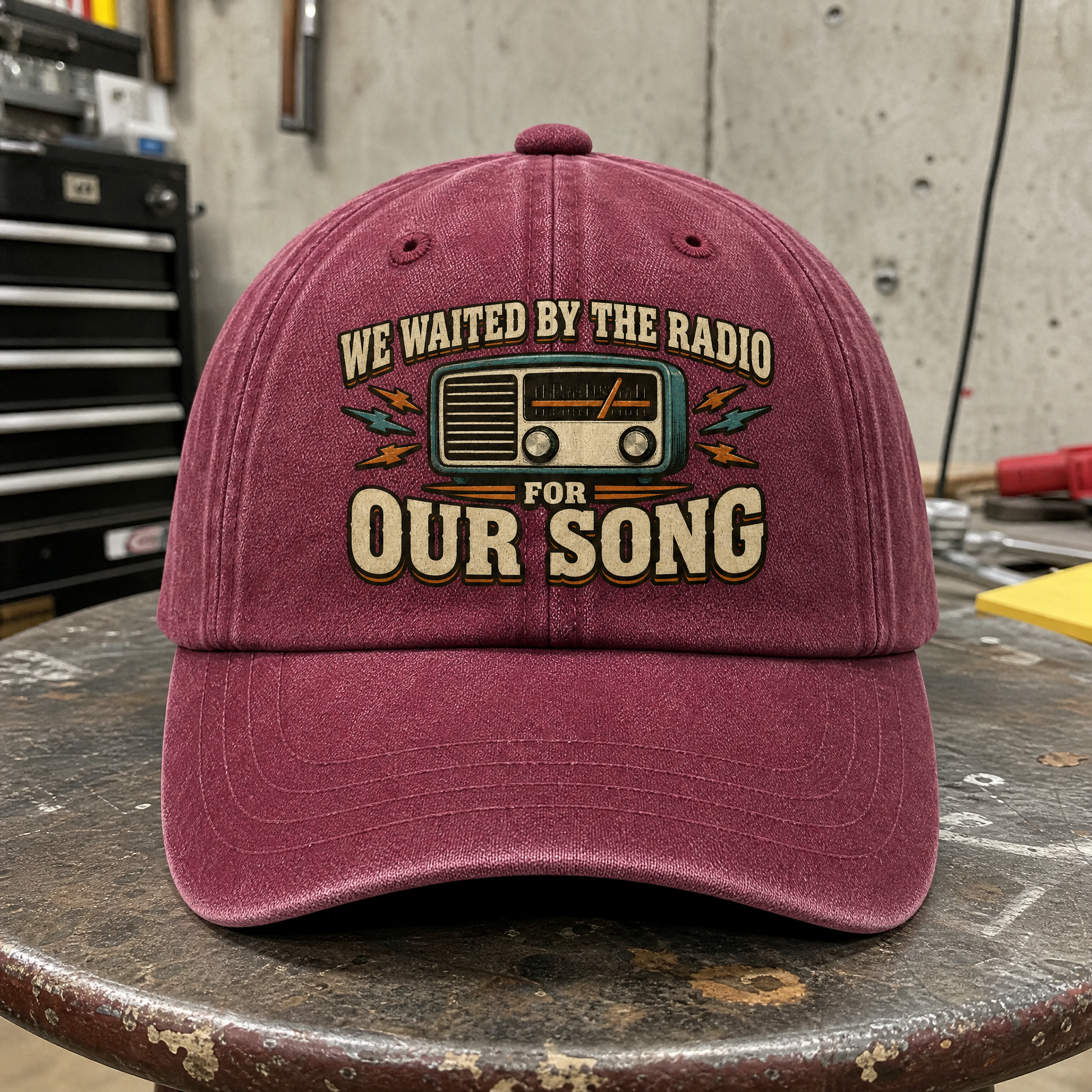Burgundy vintage washed cap with printed radio graphic and “We Waited” slogan