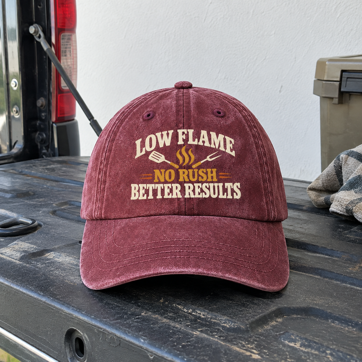 Burgundy vintage washed cap with printed Low Flame. No Rush. Better Results slogan