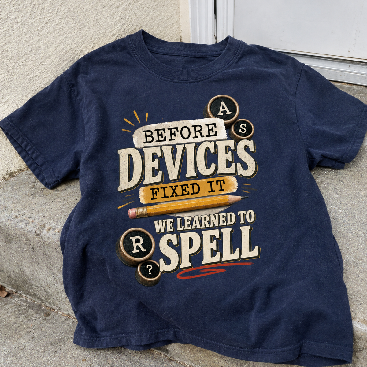 Navy vintage t-shirt featuring printed “Before Devices Fixed It We Learned To Spell” slogan