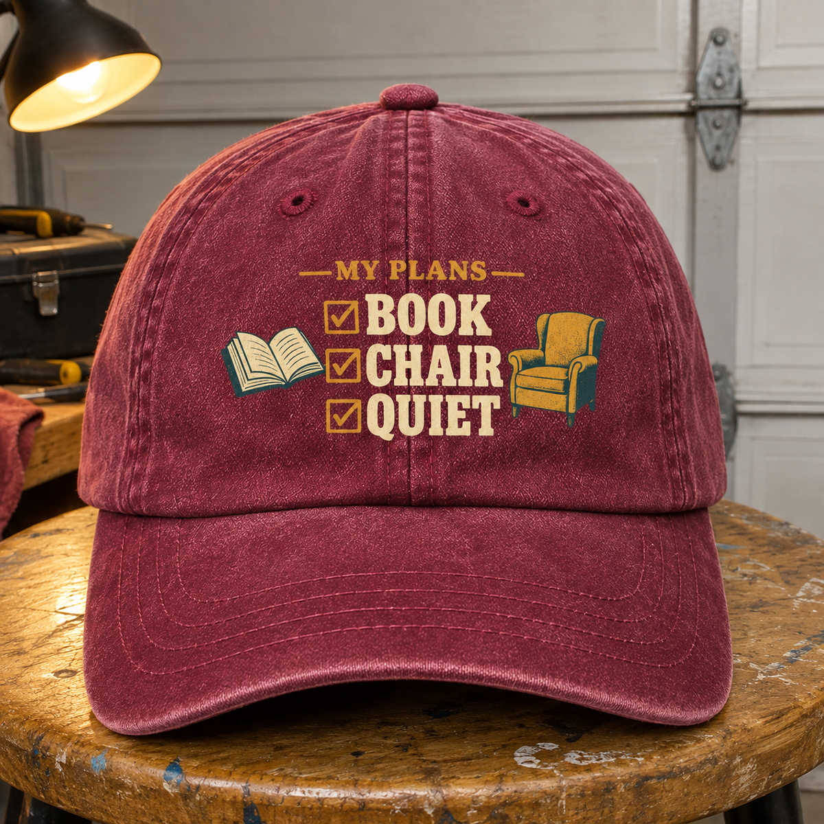 Burgundy vintage washed cap with printed My Plans Book Chair Quiet design, front hero view