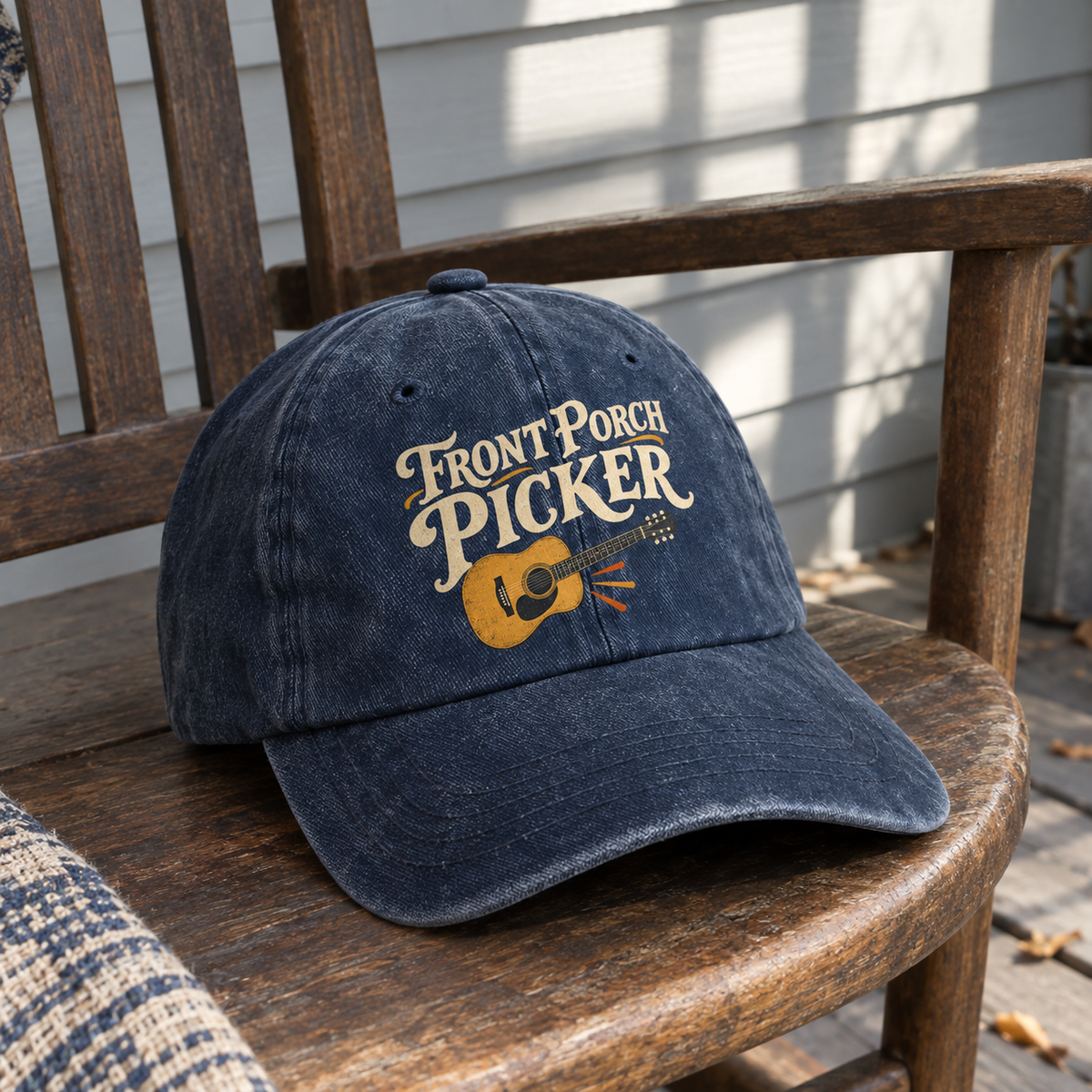 Vintage washed cap in navy with Front Porch Picker guitar print on wooden porch chair