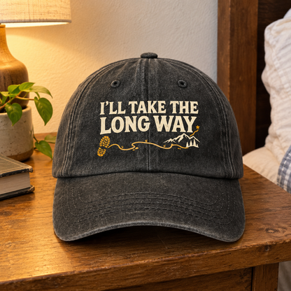 Black vintage washed cap with printed “I’LL TAKE THE LONG WAY” slogan and mountain graphic