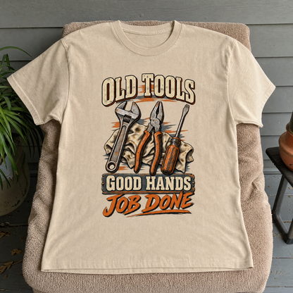 Beige vintage t-shirt featuring printed old tools and Good Hands Job Done slogan.