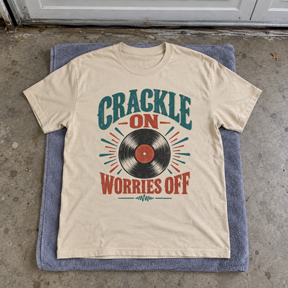 Cream vintage t-shirt laid flat with printed Crackle On Worries Off record design