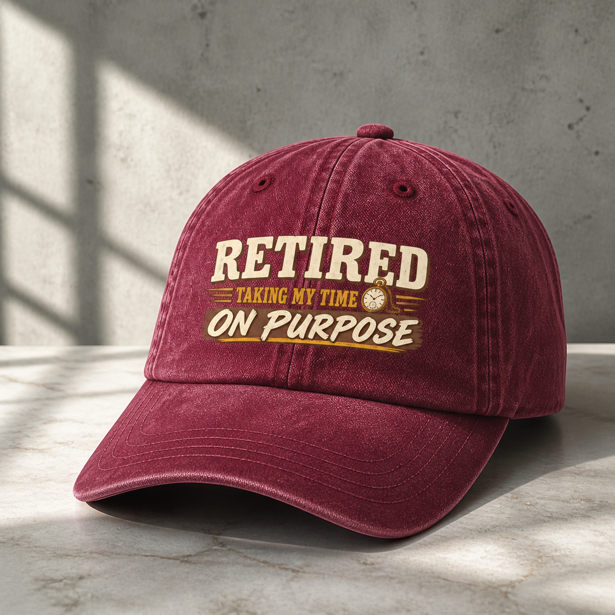 Burgundy vintage washed cap with printed “Retired. Taking My Time On Purpose” slogan, hero view.