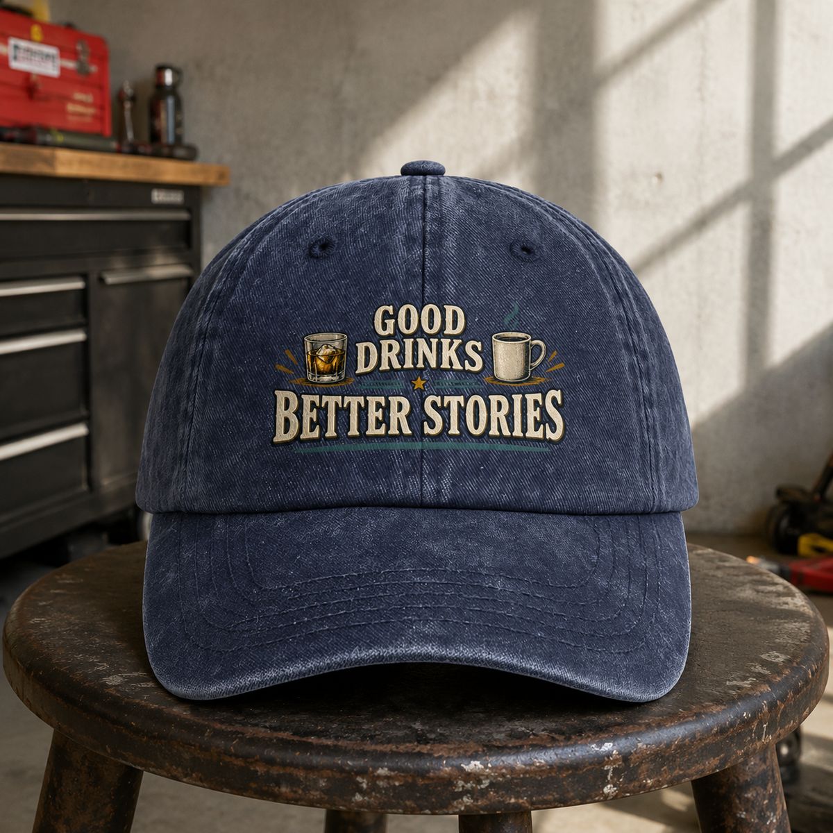 Navy vintage washed cap with printed “Good Drinks. Better Stories” slogan, front hero view.