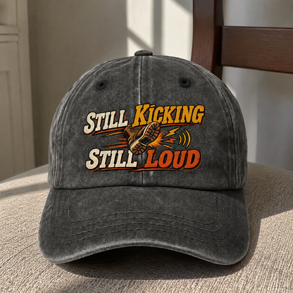 Black vintage washed cap with printed Still Kicking Still Loud design, front hero view
