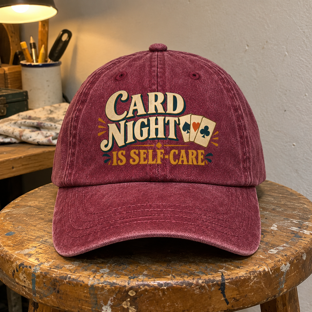 Burgundy vintage washed cap with printed Card Night Is Self-Care slogan and playing cards