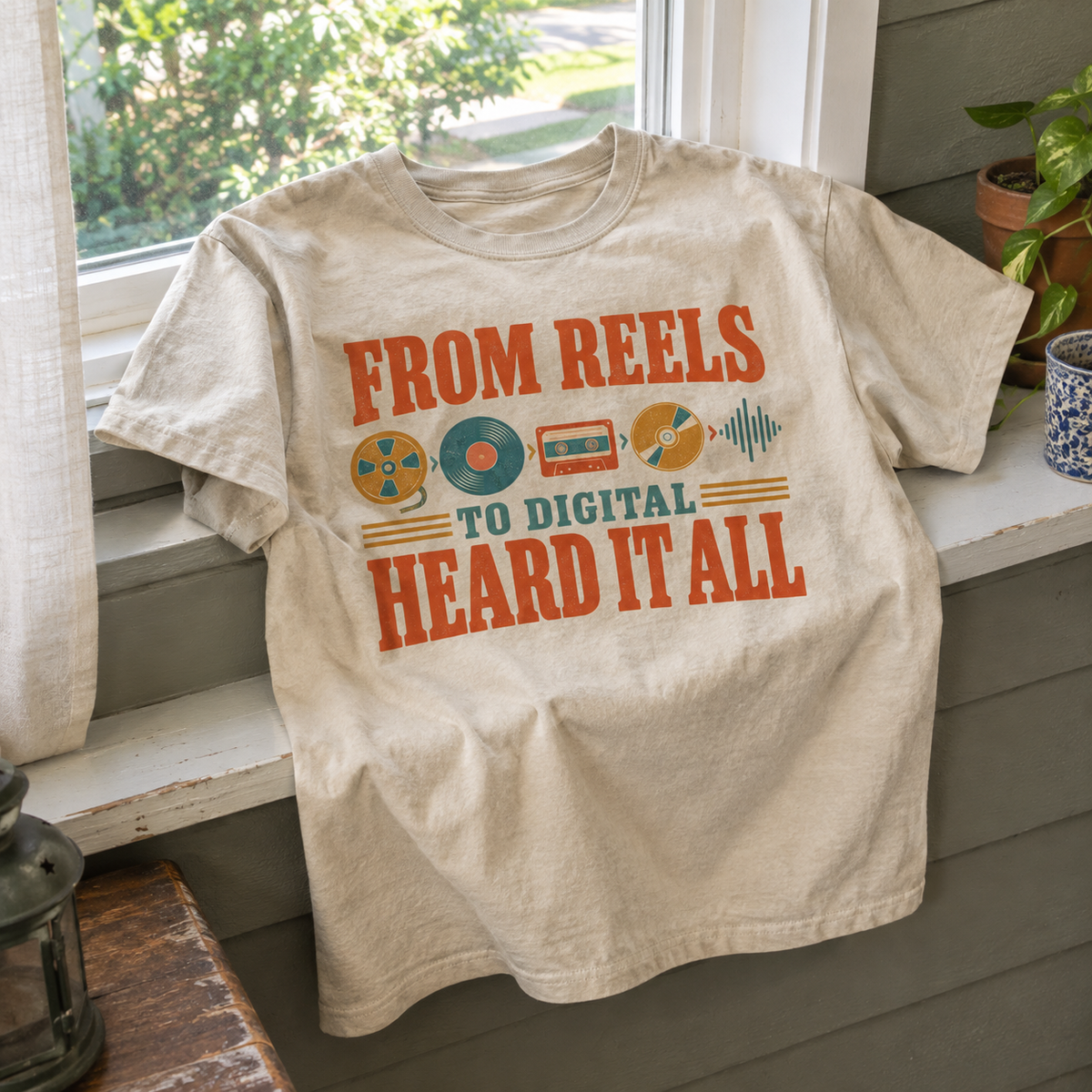 Cream vintage t-shirt with “From Reels To Digital Heard It All” printed design, front view.