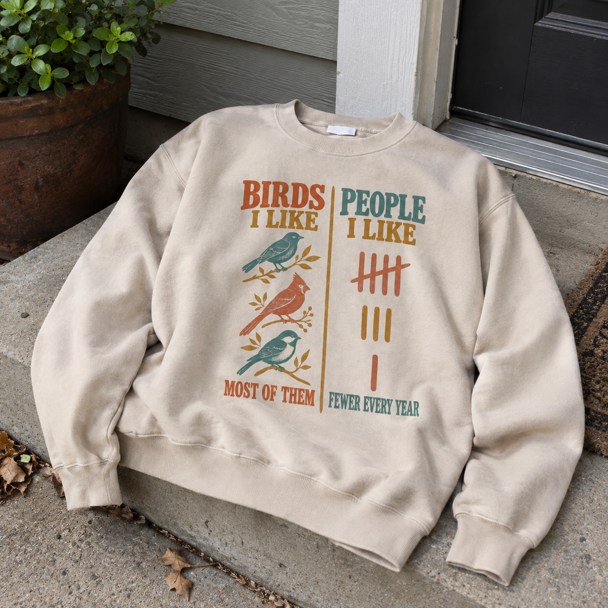 Beige vintage sweatshirt with printed bird design and humorous people slogan, front view outdoors