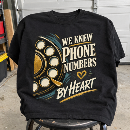 Black vintage t-shirt with printed “We Knew Phone Numbers By Heart” slogan, front view