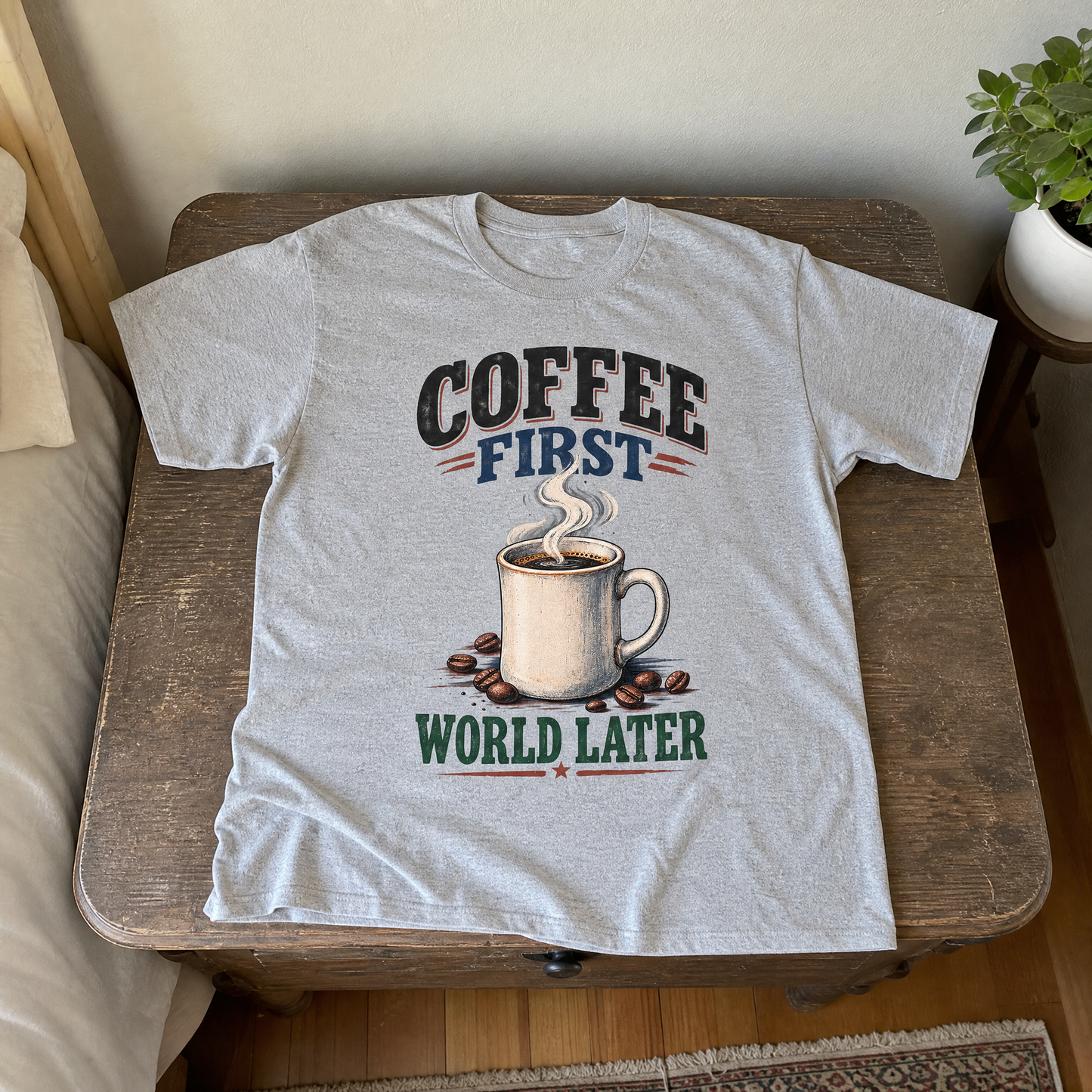Gray vintage t-shirt with printed “Coffee First. World Later” design featuring steaming coffee mug.