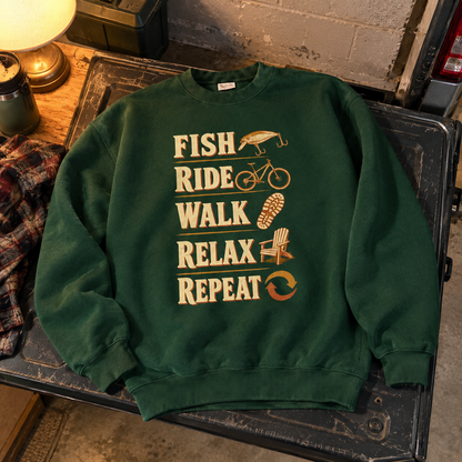 Green vintage sweatshirt with printed Fish Ride Walk Relax Repeat slogan, shown flat.