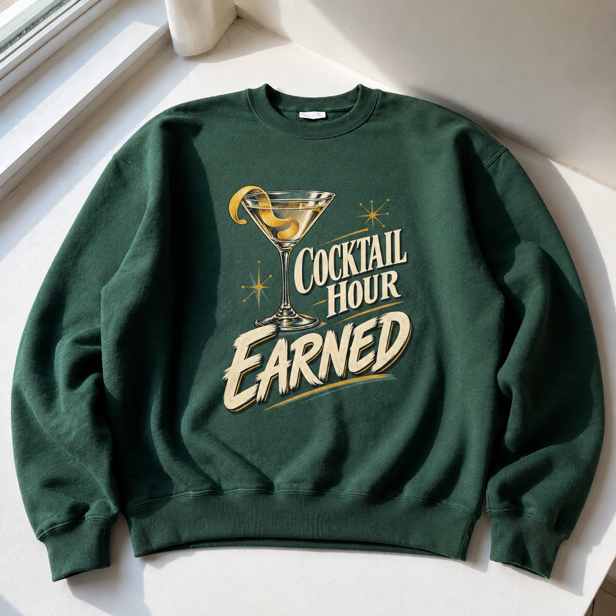 Dark green vintage sweatshirt with printed Cocktail Hour Earned cocktail glass design, hero view.