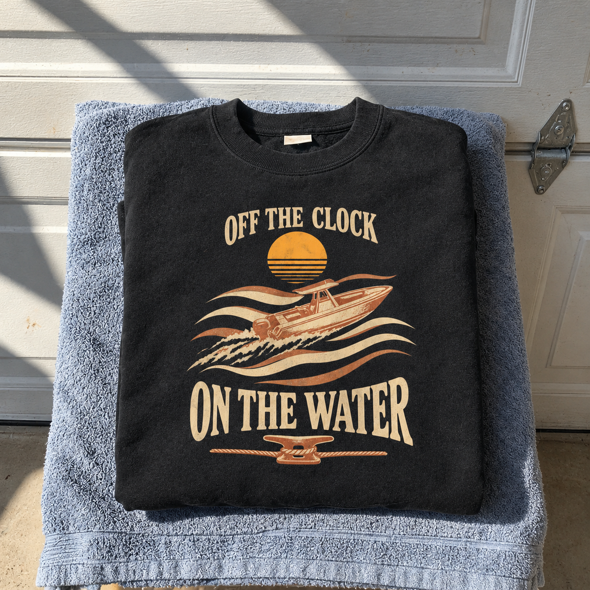 Black vintage sweatshirt printed with Off The Clock On The Water boat design, front view
