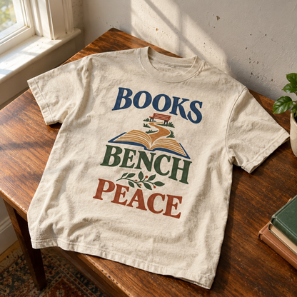 Cream vintage t-shirt with printed Books Bench Peace design on wooden table