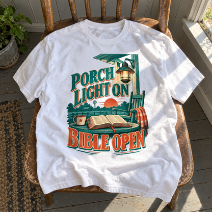White vintage t-shirt on wooden chair with printed Porch Light On Bible Open design