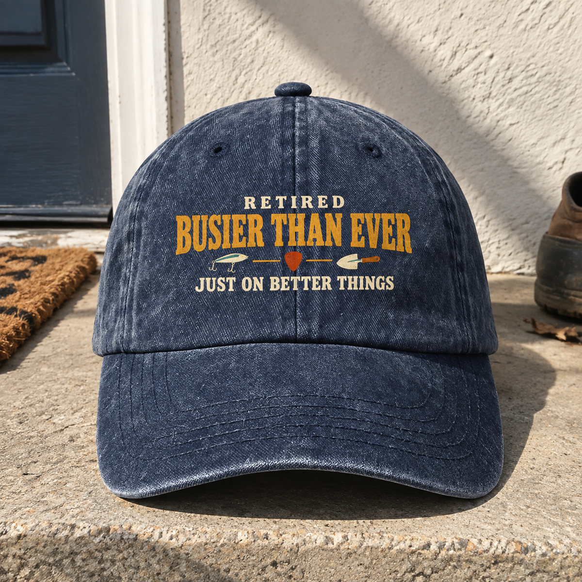 Navy vintage washed cap with printed “Retired Busier Than Ever” slogan, front hero view