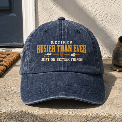 Navy vintage washed cap with printed “Retired Busier Than Ever” slogan, front hero view