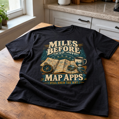 Black vintage t-shirt with printed “Miles Before Map Apps Still Knew The Way” design, flat lay view