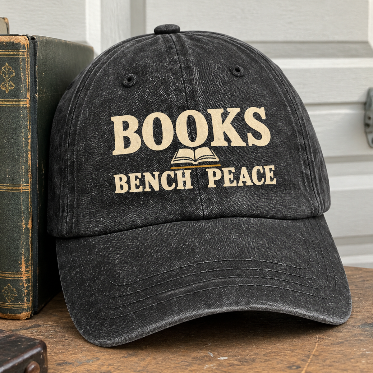 Black vintage washed cap with printed Books Bench Peace slogan, front hero view