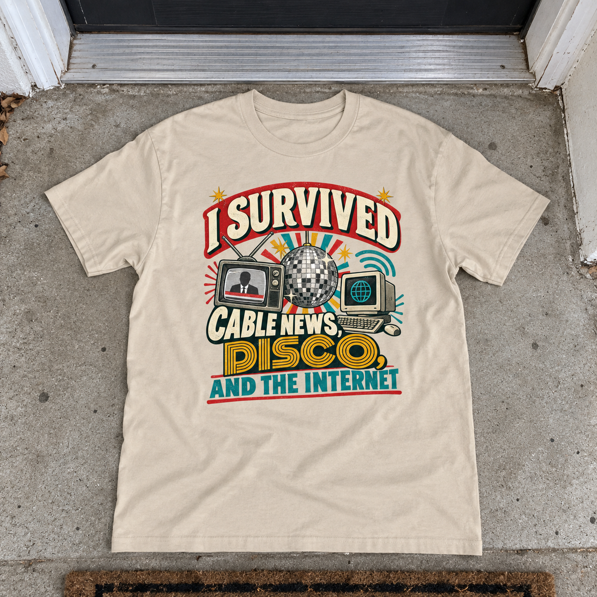 Cream vintage t-shirt laid flat with printed I Survived Cable News, Disco, And The Internet